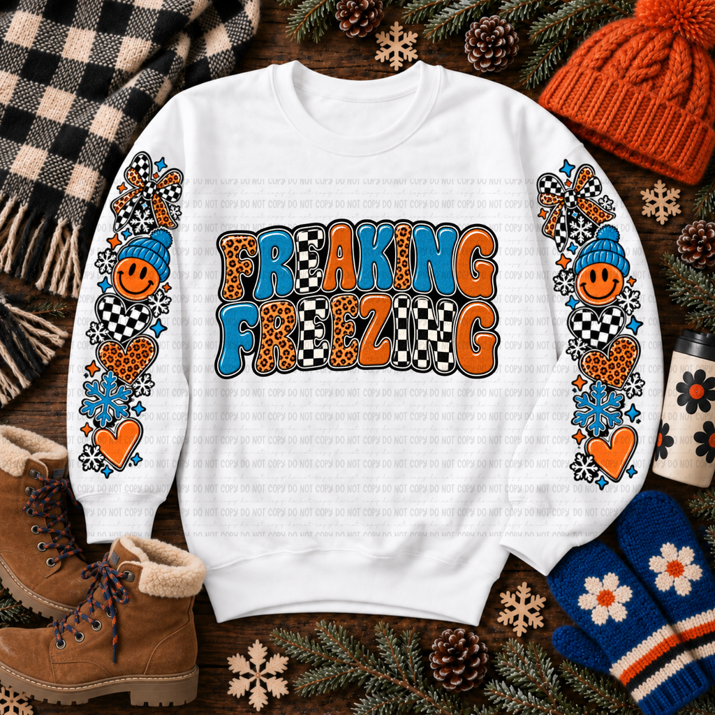 White Freaking Freezing sweatshirt with colorful winter graphics, snowflakes, bows, and hearts