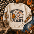 Cream Good Things Take Flight sweatshirt with an orange butterfly, lightning bolt, stars, and fall details