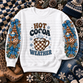 White Hot Cocoa Weather sweatshirt with blue bows, hot cocoa mugs, snowflakes, and winter trees