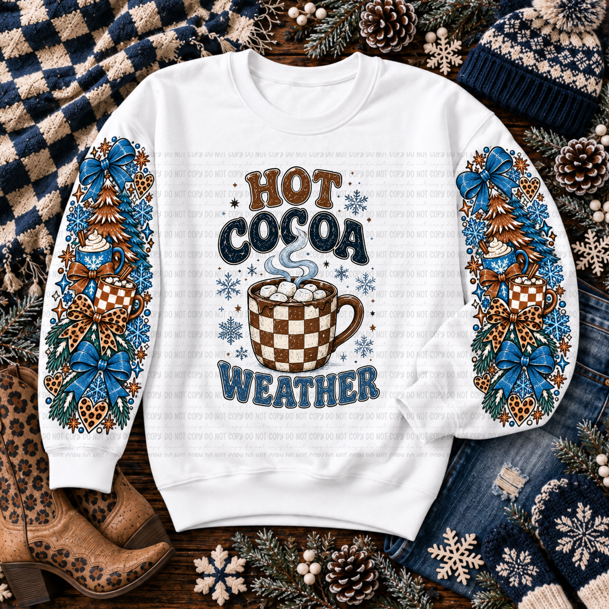 White Hot Cocoa Weather sweatshirt with blue bows, hot cocoa mugs, snowflakes, and winter trees