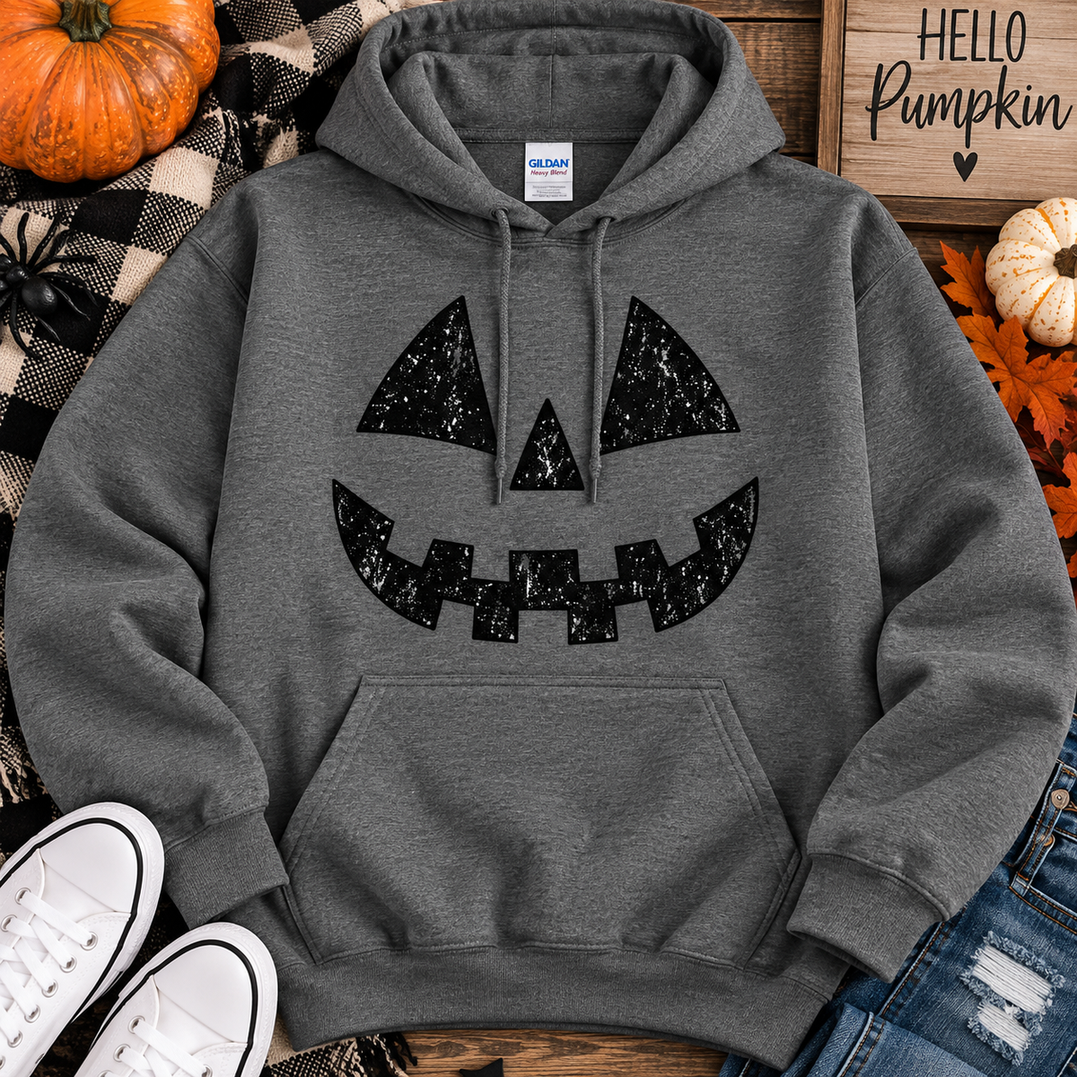 Dark grey hoodie with distressed jack-o'-lantern face design