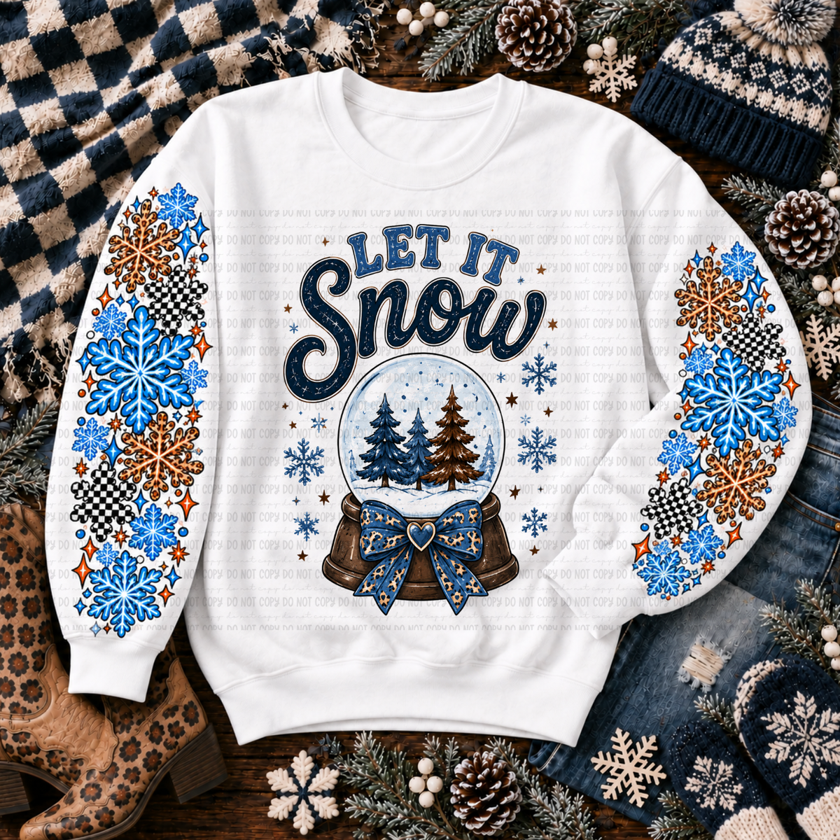 White sweatshirt with a Let It Snow snow globe design and colorful snowflakes