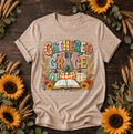 Gathered by Grace T-Shirt with pumpkins, sunflowers, and open Bible design