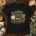 Black graphic T-shirt with coffee cups and the phrase A Little Moody, A Lot Caffeinated