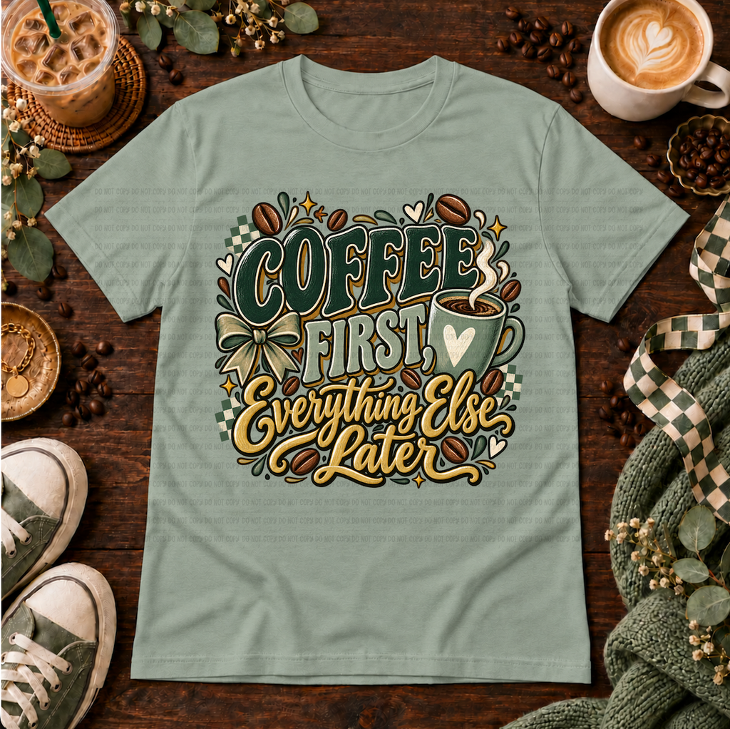Sage green graphic T-shirt with coffee beans, a coffee cup, bow, and the phrase Coffee First Everything Else Later