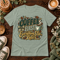 Sage green graphic T-shirt with coffee beans, a coffee cup, bow, and the phrase Coffee First Everything Else Later