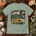 Sage green t-shirt with Just One More Cup coffee design