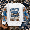 White sweatshirt with stacked sweaters, colorful evergreen trees, snowflakes, stars, and Sweater Weather lettering