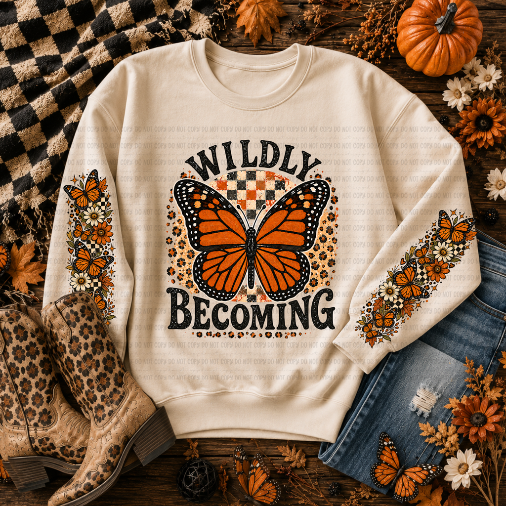 Cream crewneck sweatshirt with an orange butterfly, floral graphics, and Wildly Becoming lettering