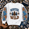 White sweatshirt with colorful winter trees, snowflakes, and Winter Wild lettering