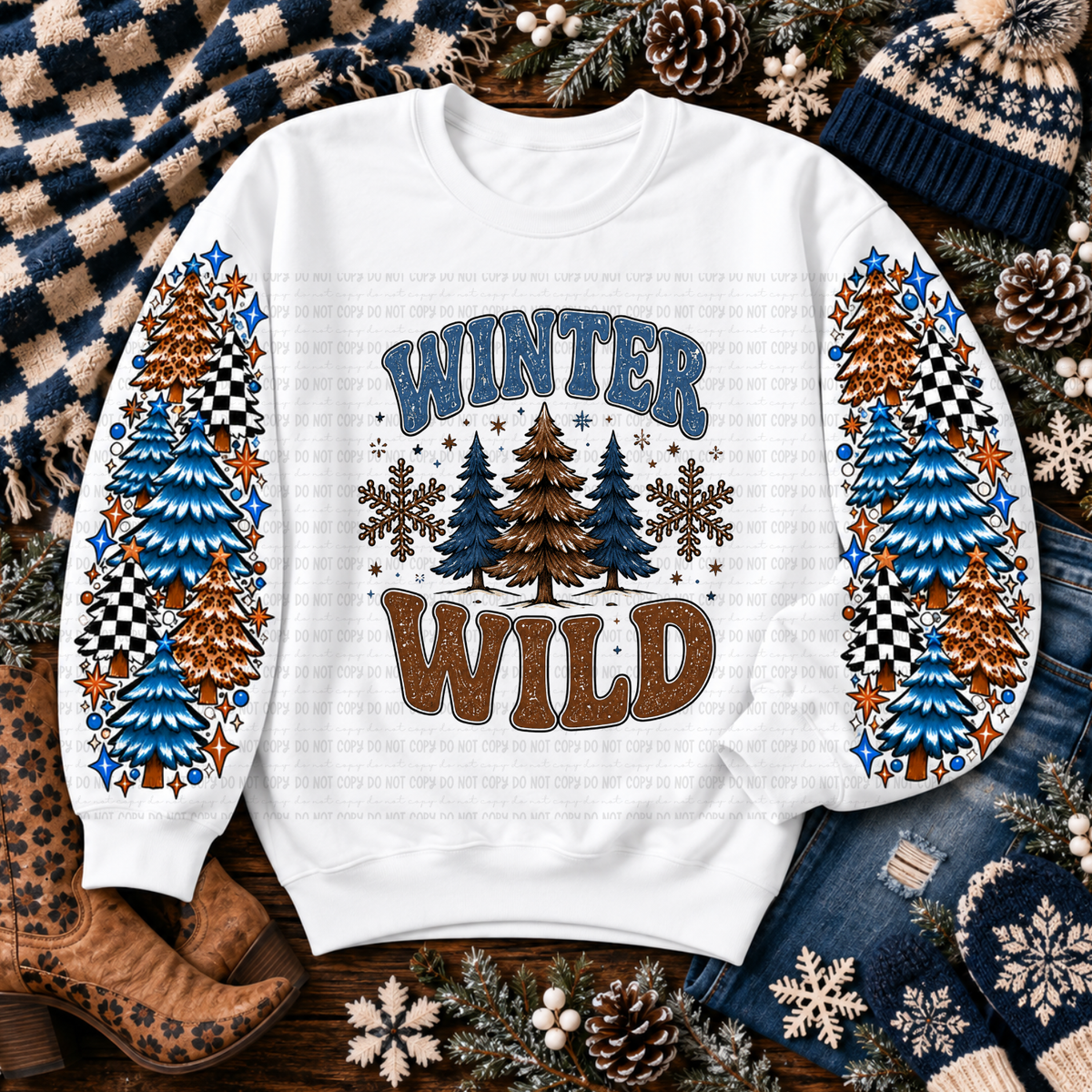 White sweatshirt with colorful winter trees, snowflakes, and Winter Wild lettering